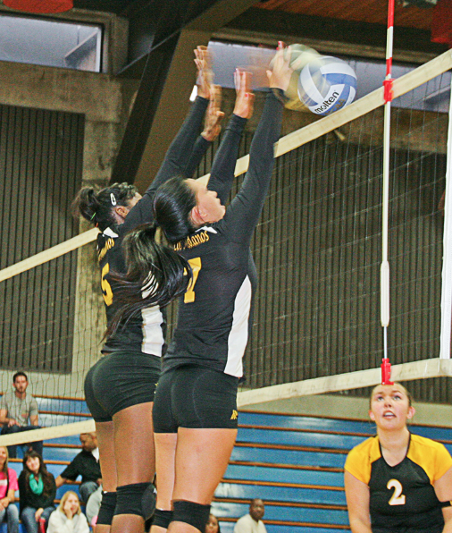 Abigail Tatman (5) and Kiana Pinkowski (7) go for a block. 