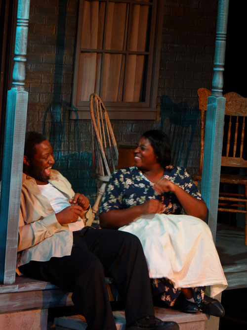 Actors Olinza Headd (left) and Arionna White (right) share a hearty laugh during a scene.
