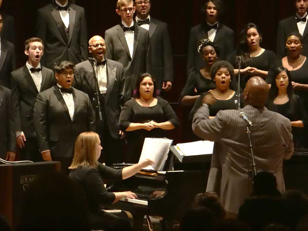Accompanist Jennifer Krey performs “I Am Not Yours” by David Dickau on the piano with director Silvester C. Henderson and his Gospel students as part of the Choral Experience Concert inside the recital hall on Tuesday evening, October 29.