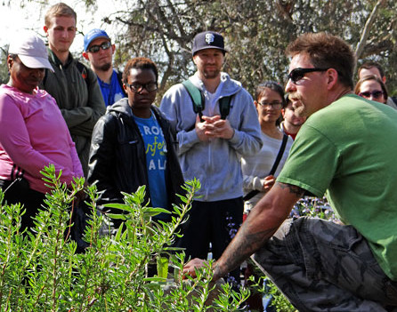 Instructional Assistant Mark Asher provides a nature lecture on plant life to Ronald Gallins Biology Science 7 class in the Outdoor Living Laboratory at the Nature Preserve Tuesday, Feb. 25.