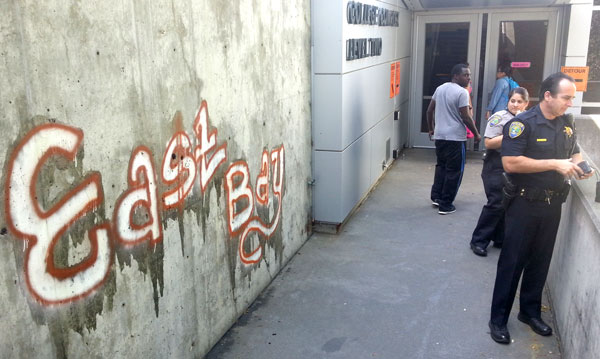 Graffiti on the wall near the College Complex Level Two entrance reading East Bay.