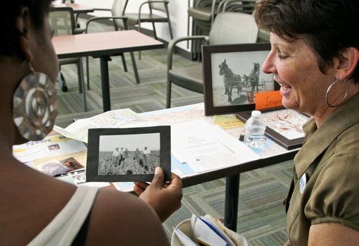 Debora Van Eckhardt shares her family genealogy photos with Aisha Hall during the Human Library event in the Library room L109. on April 15, 2014 at LMC in Pittsburg, Calif.