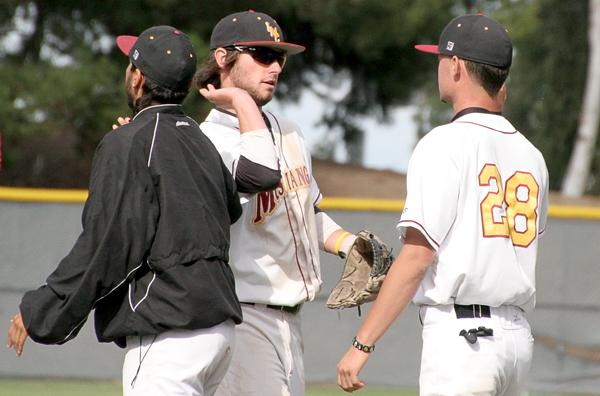 Shortstop Ryan Lacy and outfielder Cameron Darling share a high five after the final game of the season, a 12-0 win over Laney College.