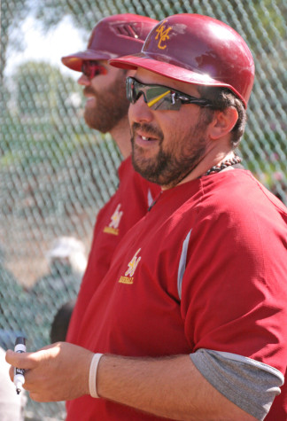 Coach D'Albora watches on with lineup in hand.