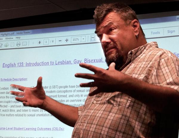 Professor Jeffrey Mitchell Matthews speaks to a small audience about what to expect in his upcoming LGBT course.