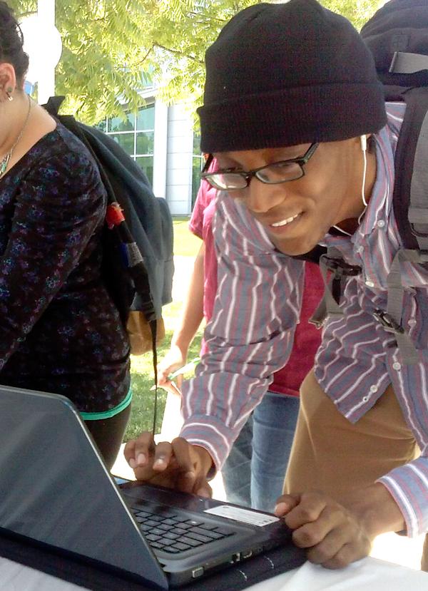 Student Malik Lawson casts his vote on one of the laptops provided. The voting was held in the outdoor quad. Voters received a free lunch for their participation.