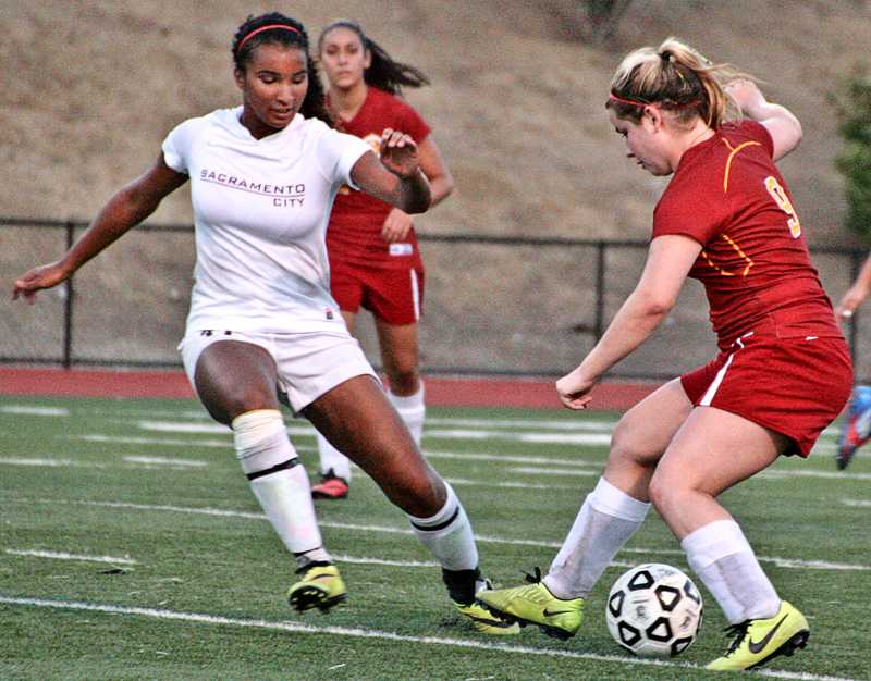Chelsea Aikman tries to get the ball away from Michelle Nunez.