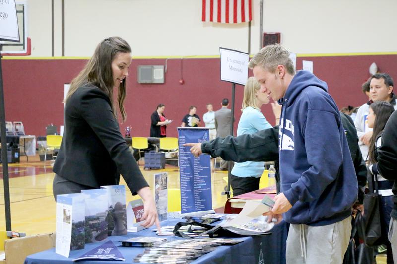 Student Andrew Olender talks to Alexandra Ball from San Diego State University during College Night, Oct. 27 in the Gym. 