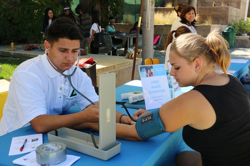 Steven Ibanez, right, checks student Brittany Matlock’s blood pressure as part of her free health screening at the Kaiser Permanente Healthy Living Event Sept. 30. The event was held in the Outdoor Quad from 10 a.m. to 1 p.m. Those who participated receieved a complimentary reusable Kaiser Permanente bag filled with tips on how to maintaining a healthy lifestyle. Other activities included free massages and information booths with advice on how to lead a healthy life.