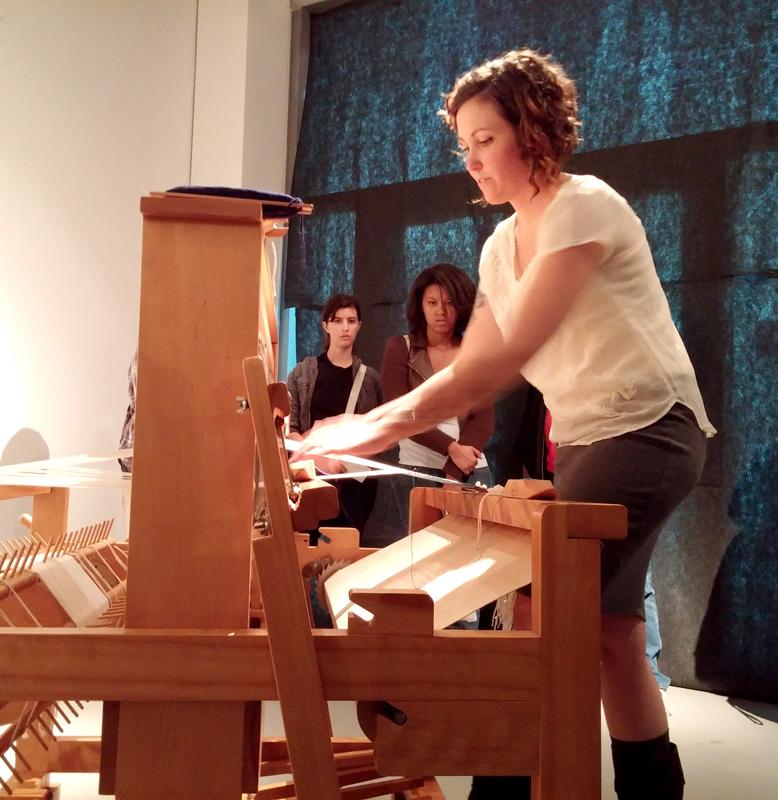 Artist in Residence and gallery intern Laurie Kelsoe demonstrates the weaving process during a reception in the Art Gallery Oct. 28.