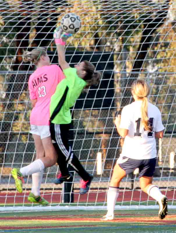 Mustangs Randi Strain collides with 49ers goalkeeper Aracely Garcia while attempting to head in the ball for a goal.