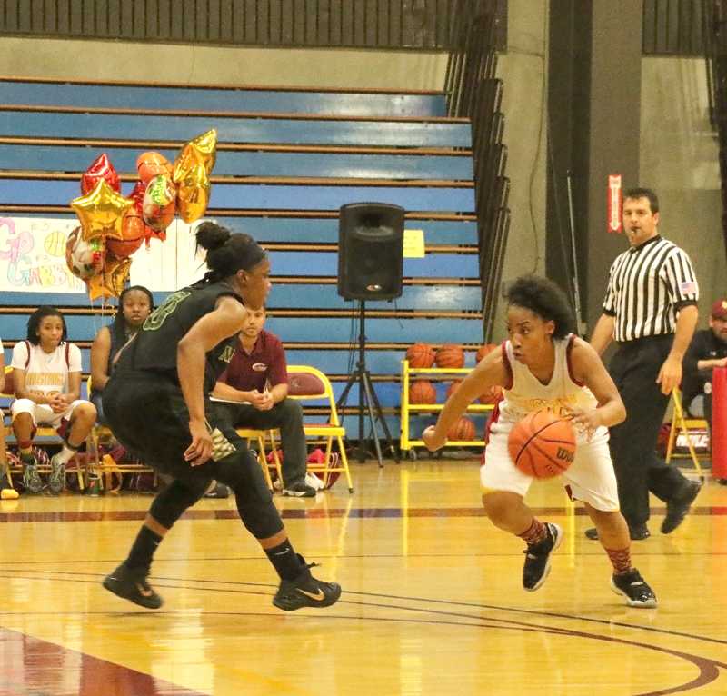 Guard Imana Samuels drives passed a Storm defender on her way to the basket.