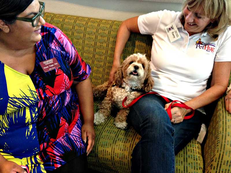 Terry Thoresen, owner of cavapoo Bella, sits with MESA Director Nichole Trager. Thoresen is a member of Tony LaRussas ARF Pet Hug pack.