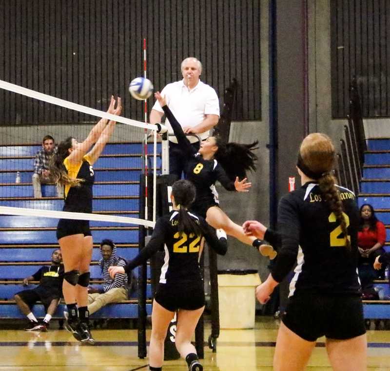 LMC’s Janessa Seei taps the ball over the net as Marin’s Tate Dobbins attempts to block. The Mustangs won all three sets of their conference bout and are third in the Bay Valley with four games remaining on the schedule.