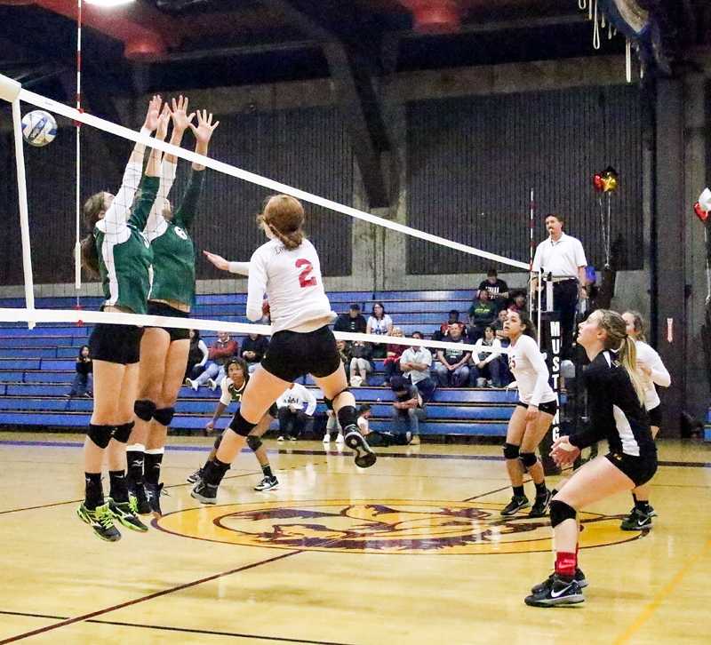LMC’s Caitlin Sadler spikes the ball over two Napa defenders during Friday night’s loss. The Mustangs finished the season fourth in conference play, missing the postseason. 