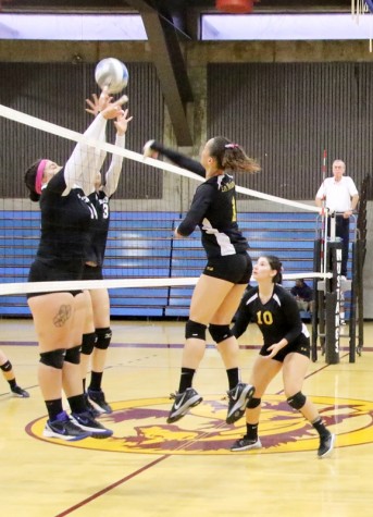 LMC's Taylor Green and Savannah Sanchez spike the ball as Solano College's Mia Satterfield-Pa'U and Hope Driscoll defend. The Mustangs won 3-2 and are 5-0 conference play second in the Bay Valley.