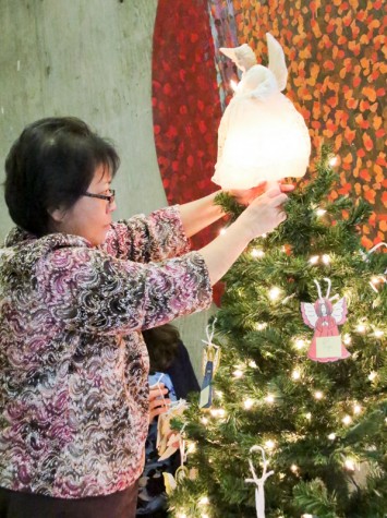 LMC Angel Tree and Toy Drive. Eileen Valenzuela is setting up this years Angel tree in the outside Business offices hallway as they have now for many years. November 30, 2015. Cathie Lawrence/Experience.