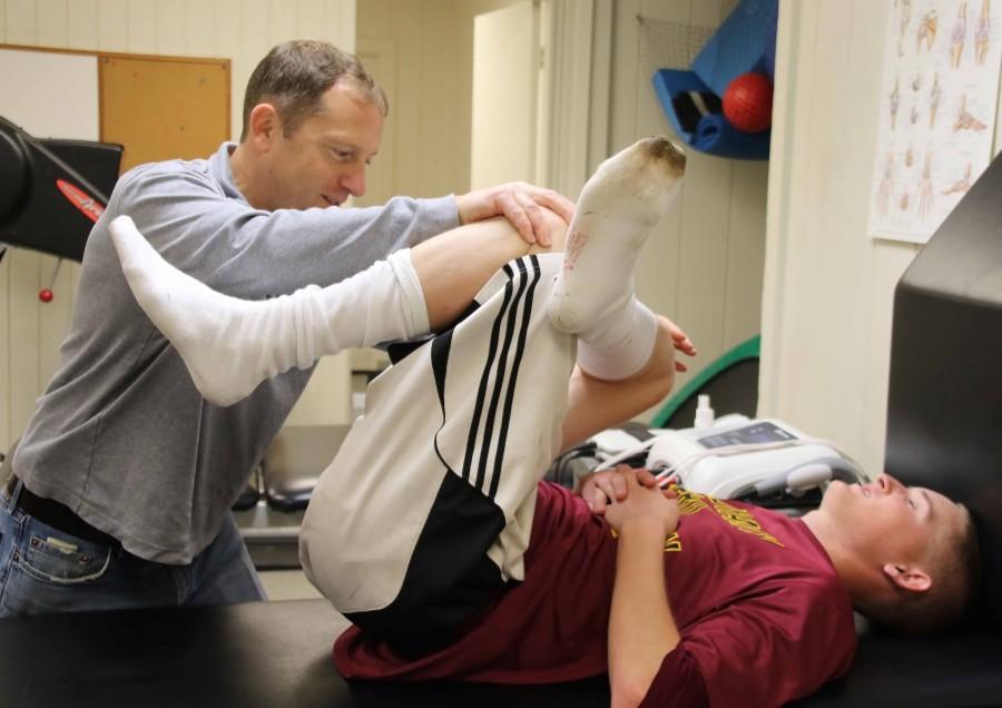 LMC athletic trainer Brian Powelson works with an injured baseball athlete.