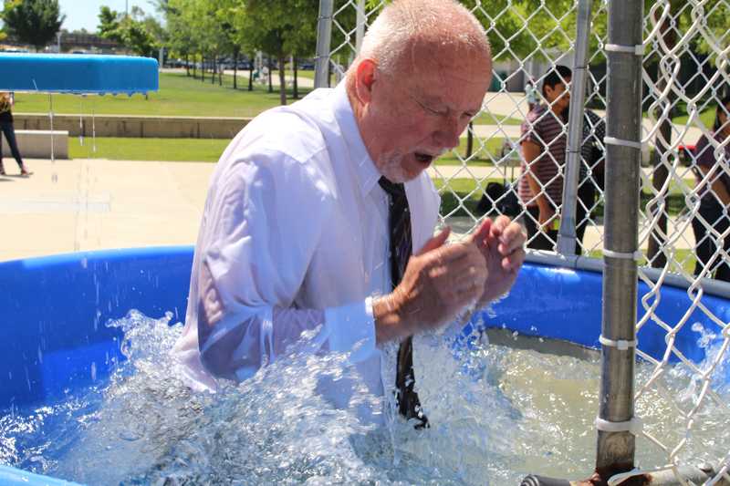 LMC President Bob Kraochvil reacts to the cold water after being one of the many individuals dunked during Pantry Project's tow-day Dunk Tank Fundraiser in the Outdoor Quad Wednesday, May 11.
