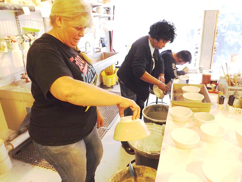 Instructional Aides Amy Ochoa (left) and Julee Richardson glazing bowls for the Empty Bowls event that the Food Bank of Contra Costa & Solano is hosting. 