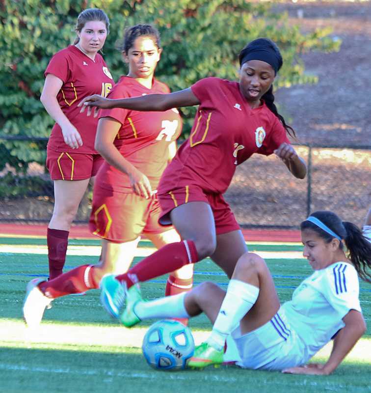 Los Medanos College’s Brianna Woodcock takes the ball away from Solano’s Marissa Crisosto while LMC’s Natalie Tunales and Haley Weder hustle to the ball.