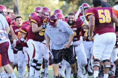 LMC Head Coach Chris Shipe gets drenched in Gatorade after his team pulls off a late victory