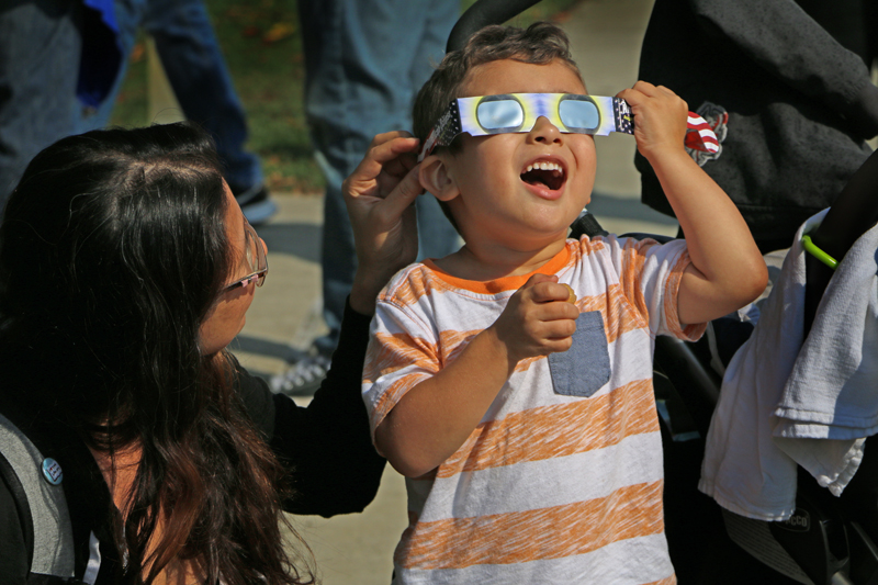 Los Medanos College student Natalie Yoshimoto and her son Elliot were able to witness the first total eclipse in 99 years to be seen across the U.S. in the Outdoor Quad Monday, Aug. 21. Students around campus came together to get a glimpse of the