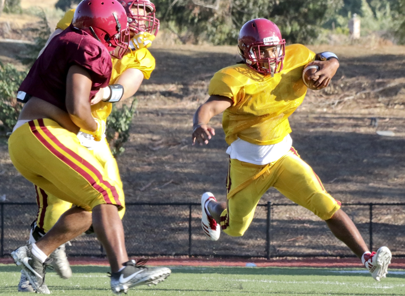 Los Medanos College running back, Namontte Grisby, tries to find his way through the defensive line during practice in preparation for the new season.