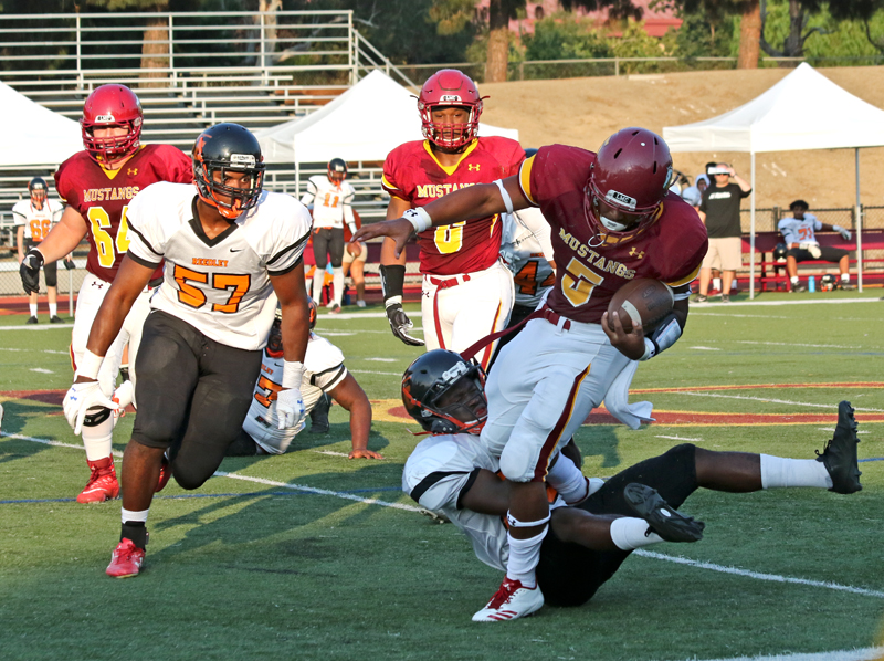 Los Medanos College Running Back Namontte Grisby tries to avoid the Reedley defense en route to the win.