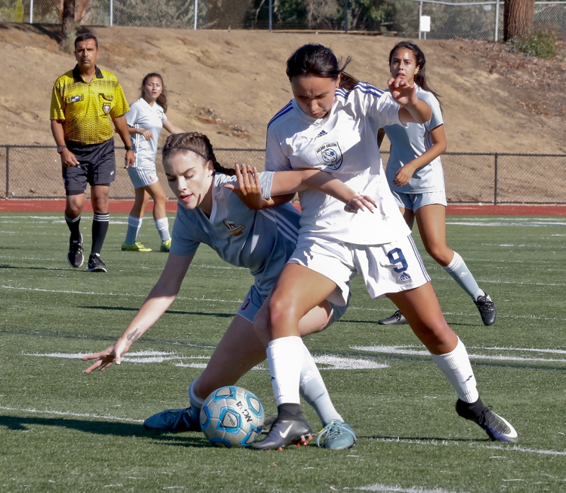 Los Medanos College’s Sydney Torrano battles for the ball with a Solano College player. 