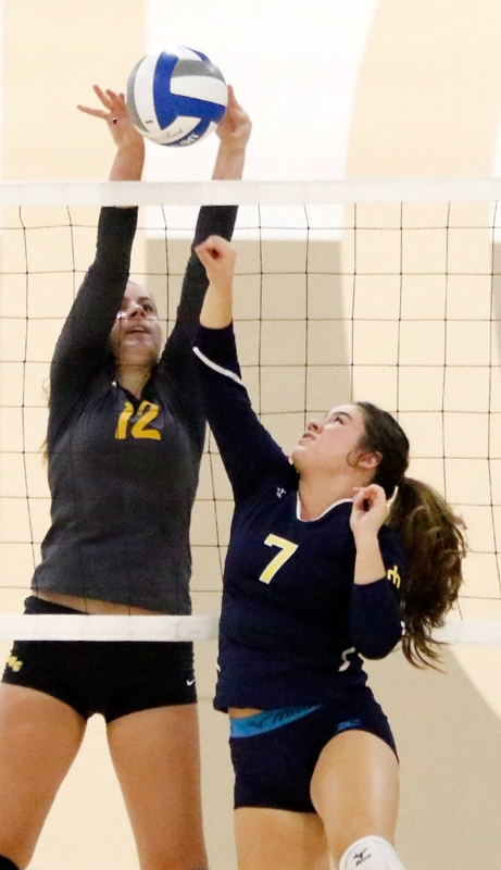 Los Medanos College volleyball player Ashley Dixon blocks the Merced College players offensive attempt.