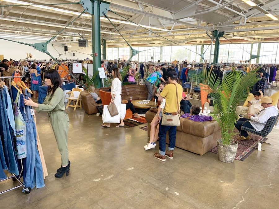 Shoppers look around the vintage market as vendors promote their newest wear. 