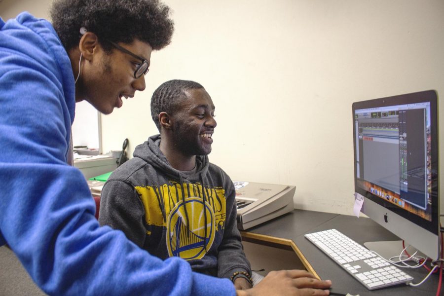 Los Medanos College Recording Arts students Devin Mason (left) and TJ Holloway work on incorporating a melody from a bass guitar into a project. 