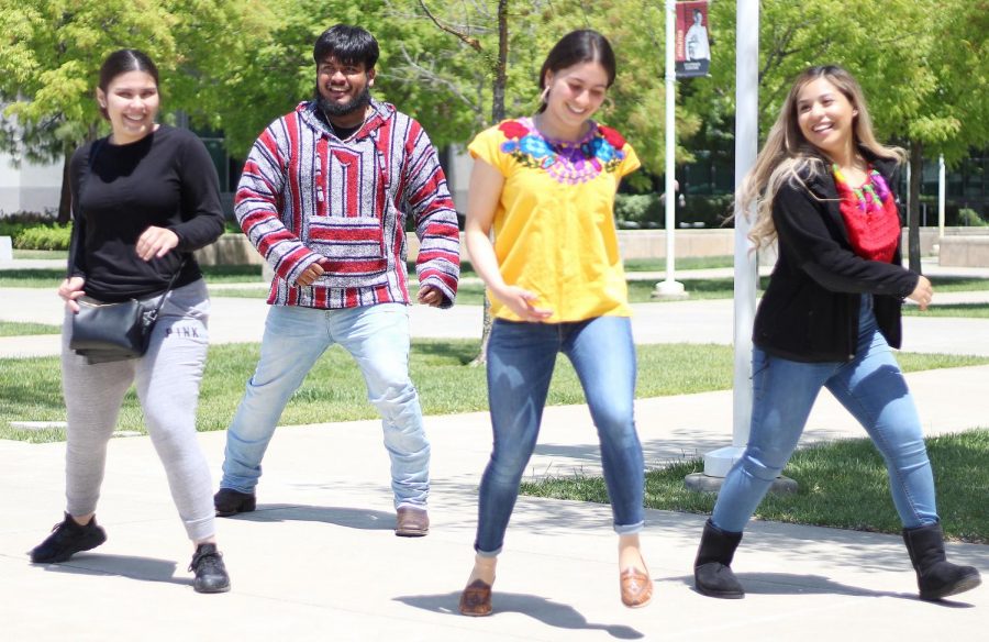 From left: A Puente, President of the United Dreams Johnathan Trejo, President of Puente Bianca Bautista and Vice President of United by Dreams Diana Longoria dance to Mi Pobre Corazon at the Cinco de Mayo event held in the outdoor quad.