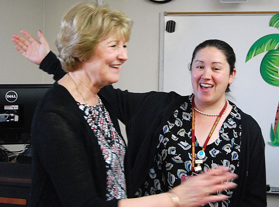 Financial aid assistant Deborah Baskin goes in to hug Gail Newman at the vp’s retirement party. 