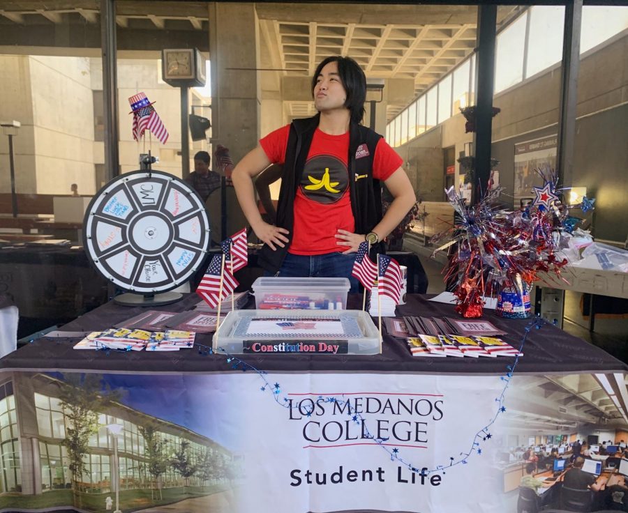 Adrian Montemayor poses over his booth, advocating for students to know about the Constitution. 