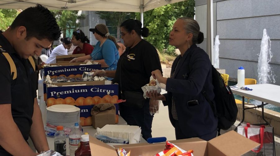 Erick Amaya • Experience
Teresea Archaga, director of Student Life, distributes food to students while Sabrina Kwist, dean of Equity and Inclusion, converses with a student during Mustang Day August 28.