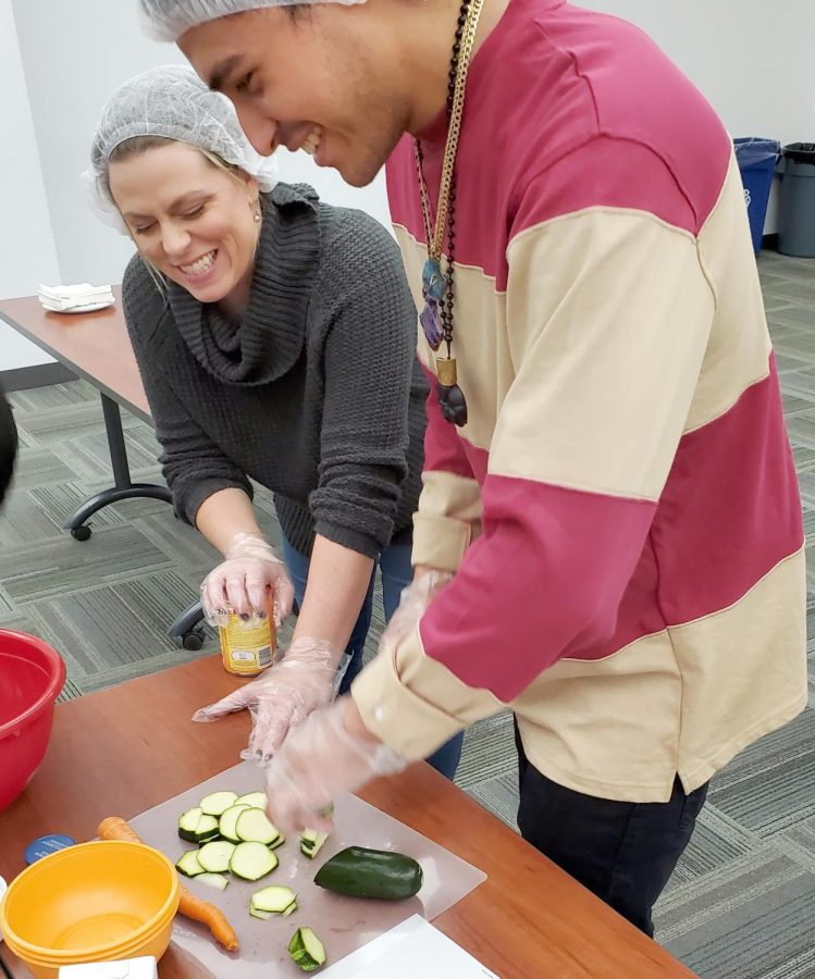 Renee Savage and Manny Jimenez prepping vegetables for corn and green chili salad.