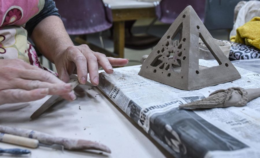 Ceramics instructional aide Nikki Vreeland crafting a piece.