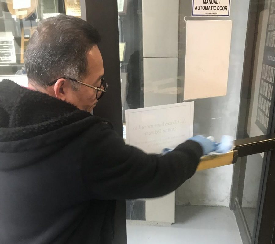 Custodian Reynaldo Flores wipes down all door handles and surfaces everyday on campus. Photo taken March, 17.