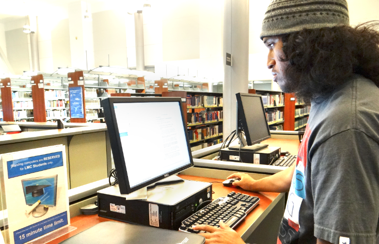 Robert McCune uses Library computers to print out his homework which students cannot do at the moment due to the closure. Photo taken in 2013.