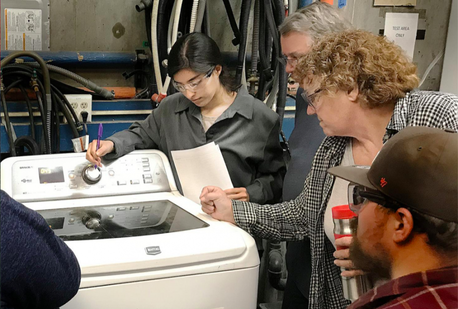 Students Marlene Lopez (left), Steve Lowery and Instructor Debra Winckler go over how to fix a washer.
Photo taken in 2019