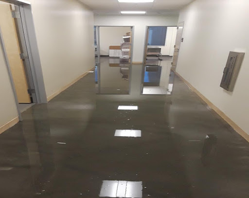 Water from the flood fills the administrative wing hallway within the new LMC Brentwood Campus.