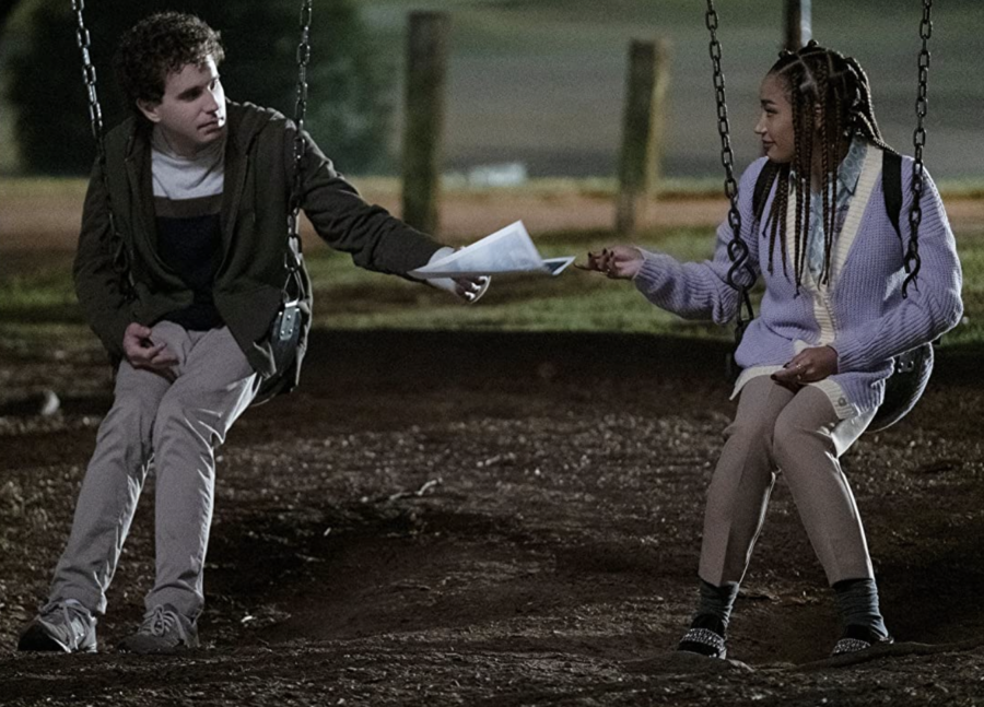 Ben Platt as Evan Hansen and Amandla Stenberg as  Alana Beck sitting together on a swing set.