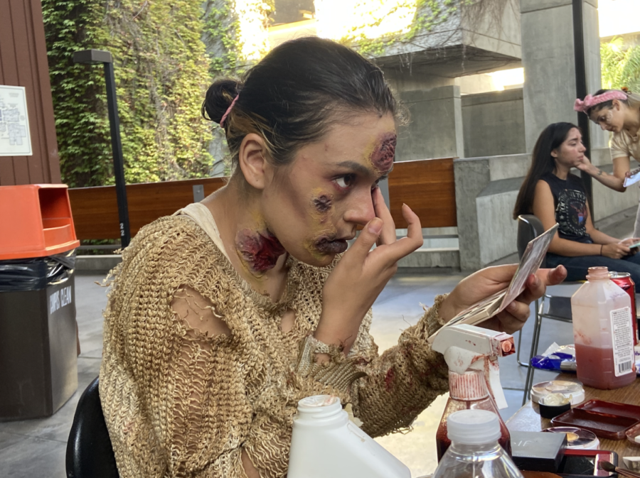 Makeup artist and actor Nyla Rahimi applies zombie makeup during the filming of “Death and Silence,” at LMC on Sunday, Sept. 26.