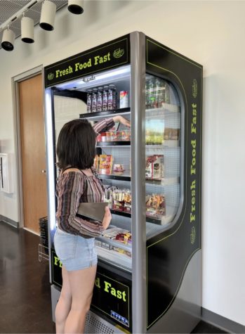 Student employee Gabriella Kellerman organizes the fridge inside the bookstore.
