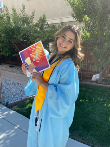 Nela Taeb dressed in her cap and gown for her high school graduation on June 3, 2021.