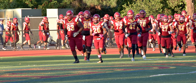 The Los Medanos Mustangs team runs out onto the field to play their week 6 game against College of the Redwoods. The Mustangs are coming off back to back wins and are looking to making it three in a row.