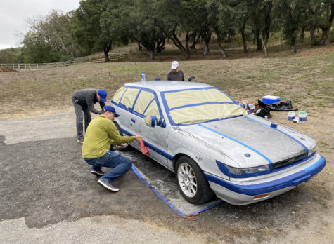 Members of Luis Zunigas race team, Team Nopar which included music students David Poe, Matt Parfit, Peter Gaylord and Mark Lawrence, paint the car in time for the race.