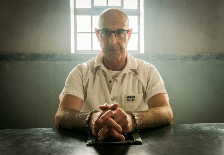 Jefferson Grieff, played by Stanley Tucci, is handcuffed to a police investigation table for questioning.